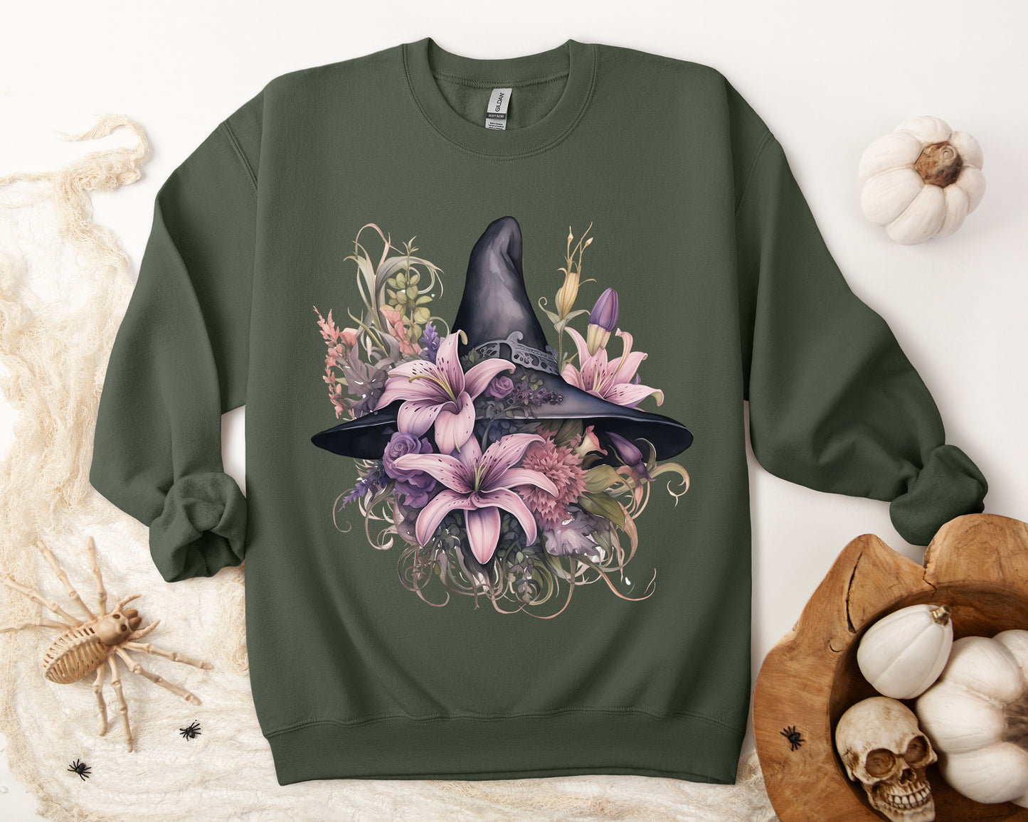 Charming Witch Hat & Flowers Sweatshirt with a watercolor illustration of a black witch hat and flowers in purple, pink, and green. Available in multiple dark and light colors and sizes. Gildan 18000 sweatshirt in Military Green. ReadyShirtAim.com