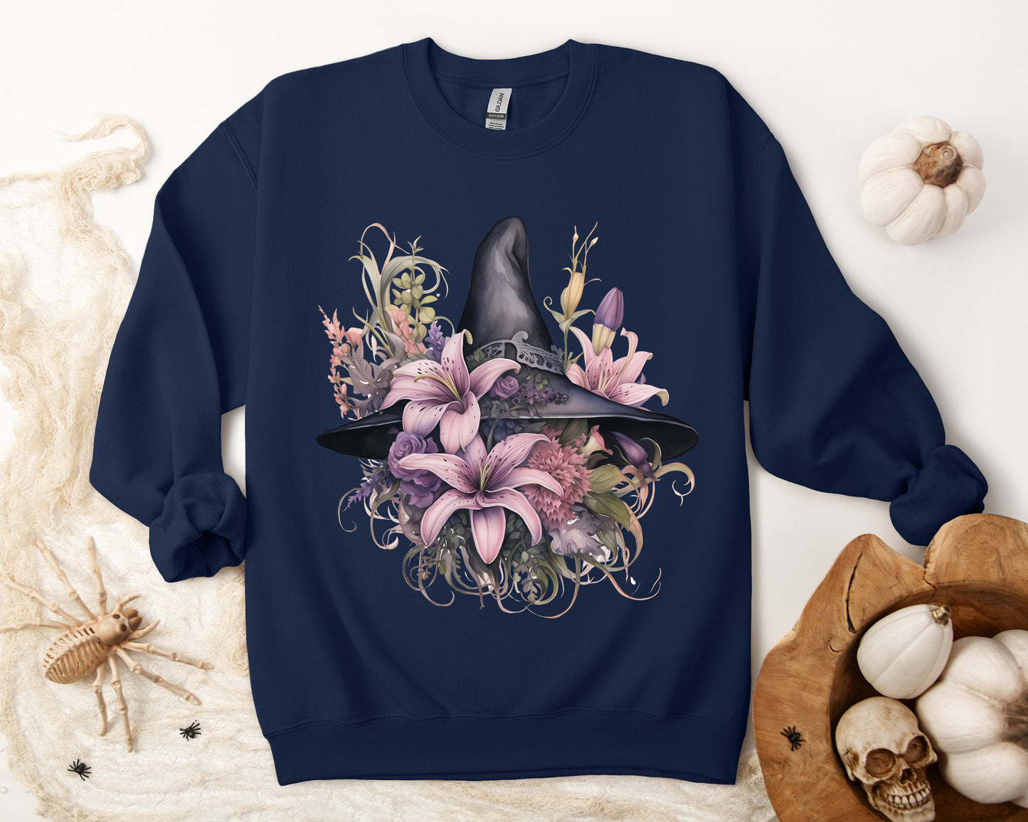 Charming Witch Hat & Flowers Sweatshirt with a watercolor illustration of a black witch hat and flowers in purple, pink, and green. Available in multiple dark and light colors and sizes. Gildan 18000 sweatshirt in Navy. ReadyShirtAim.com