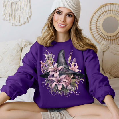 Charming Witch Hat & Flowers Sweatshirt with a watercolor illustration of a black witch hat and flowers in purple, pink, and green. Available in multiple dark and light colors and sizes. Gildan 18000 sweatshirt in Purple. ReadyShirtAim.com