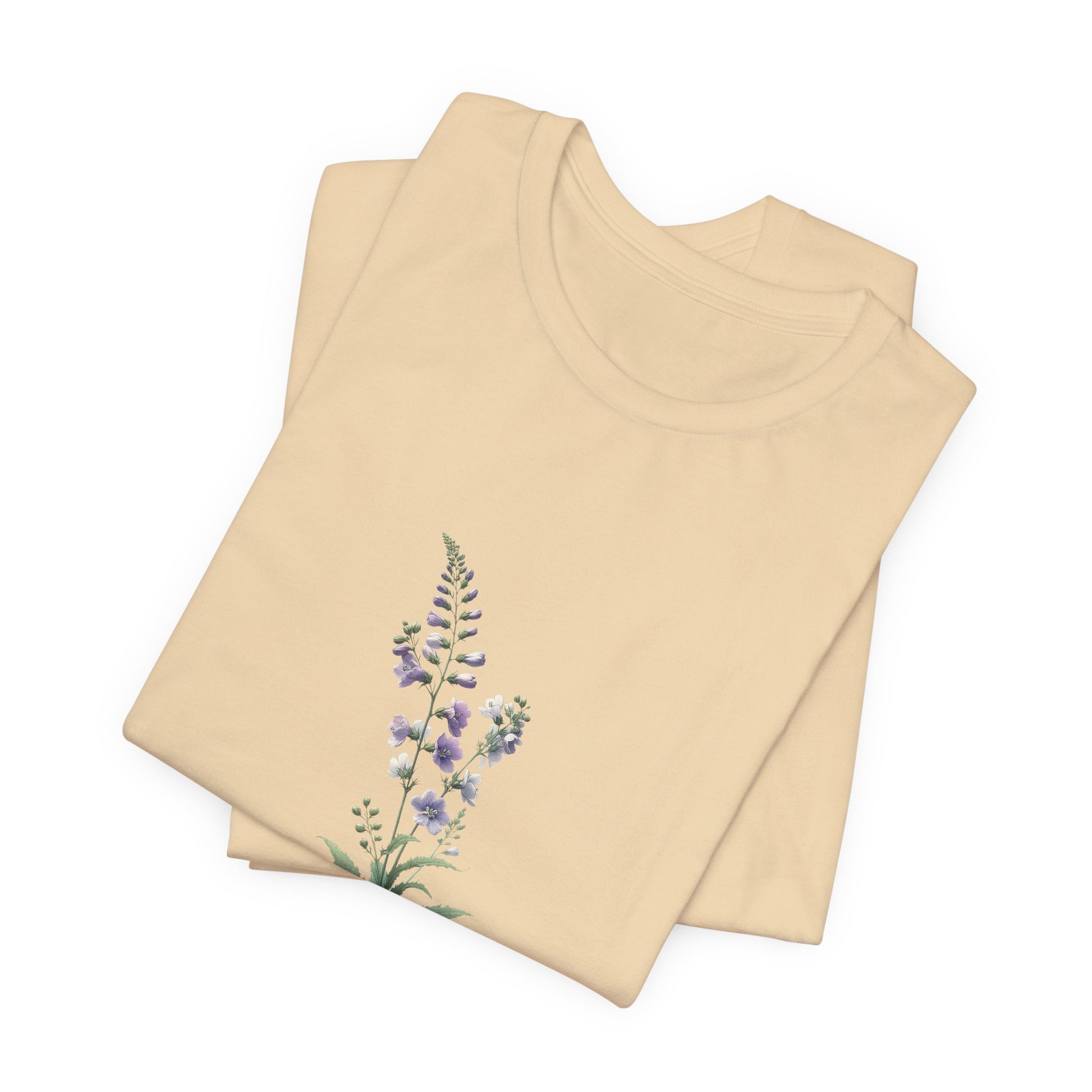 A t-shirt featuring a beautiful larkspur for July. Perfect for July birthdays and floral art lovers. Comfortable and stylish for casual outings or celebrations. Bella+Canvas 3001 t-shirt in soft cream. ReadyShirtAim.com