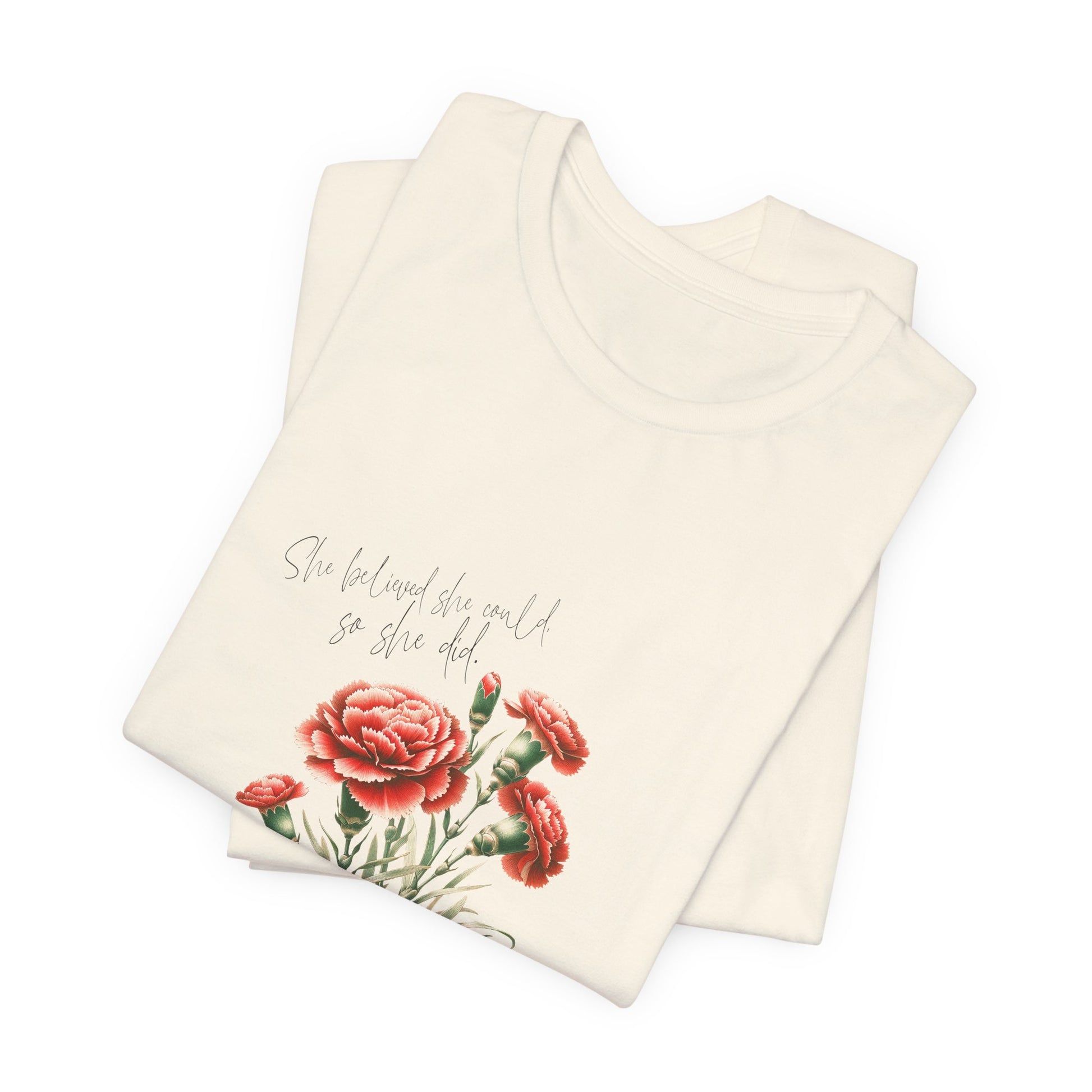 A t-shirt featuring a beautiful carnation for January with the quote “She believed she could, so she did.” Perfect for January birthdays and floral art lovers. Comfortable and stylish for casual outings or celebrations. Bella+Canvas 3001 t-shirt in natural. ReadyShirtAim.com