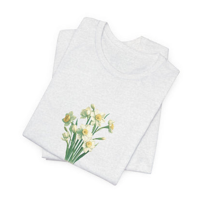 A t-shirt featuring a beautiful narcissus for December with the quote “Peaceful mind, grateful heart.” Perfect for December birthdays and floral art lovers. Comfortable and stylish for casual outings or celebrations. Bella+Canvas 3001 t-shirt in ash. ReadyShirtAim.com