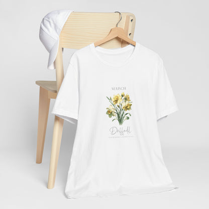 A t-shirt featuring a beautiful daffodil for March with traits New Beginnings, Happiness, Joy. Perfect for March birthdays and floral art lovers. Comfortable and stylish for casual outings or celebrations. Bella+Canvas 3001 t-shirt in white. ReadyShirtAim.com