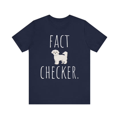 "Fact Checker" Maltese Dog T-Shirt for Unisex with a cute graphic of a Maltese dog and playful "Fact Checker" text underneath. Ideal for dog lovers. Ideal for dog lovers with a sense of humor. Bella+Canvas 3001 t-shirt in navy. ReadyShirtAim.com