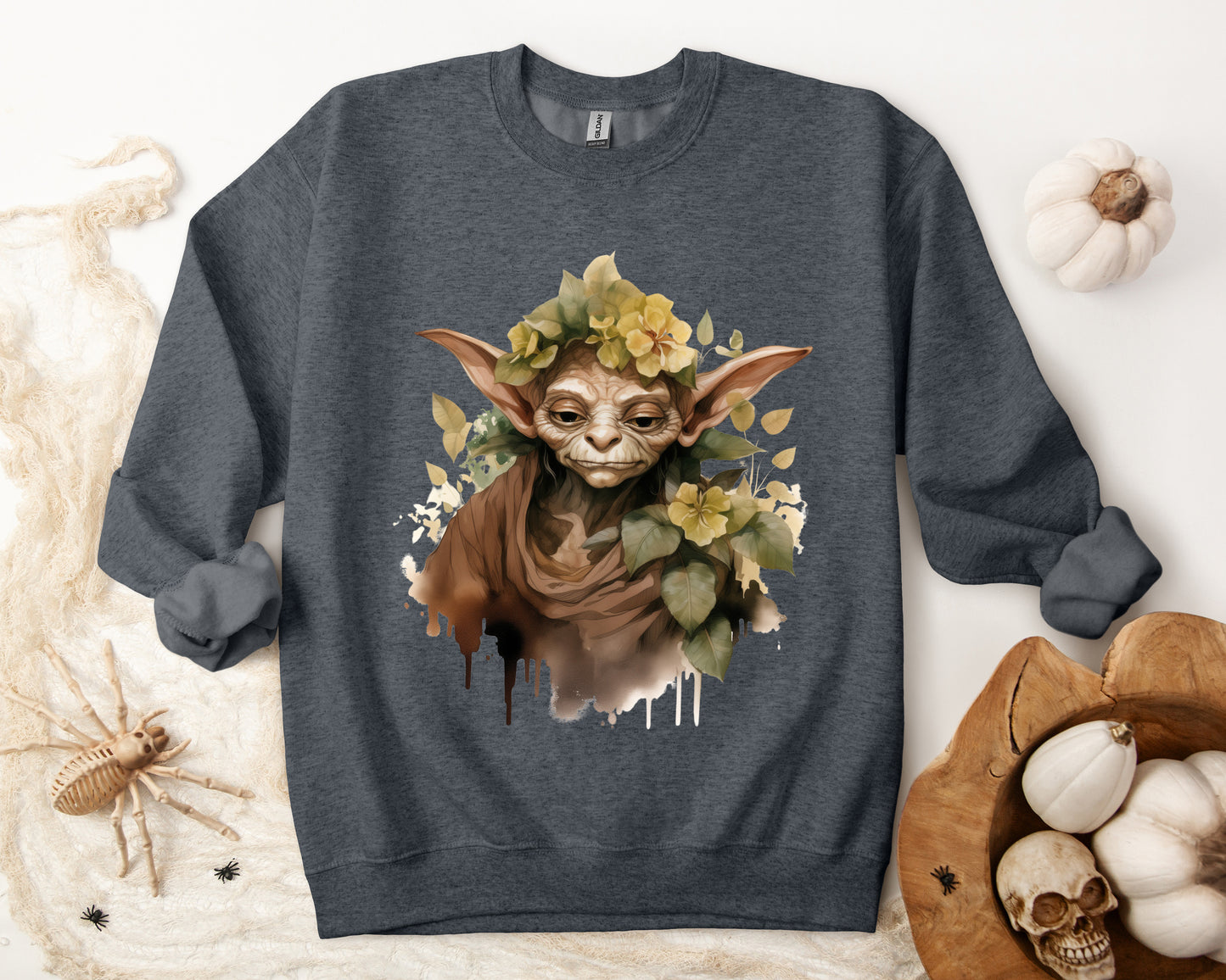 Mystical Goblin Boho Halloween Sweatshirt with a hand-drawn goblin illustration and boho-inspired design elements. Perfect for Halloween celebrations. Available in multiple dark and light colors and sizes. Gildan 18000 sweatshirt in Dark Grey Heather. ReadyShirtAim.com