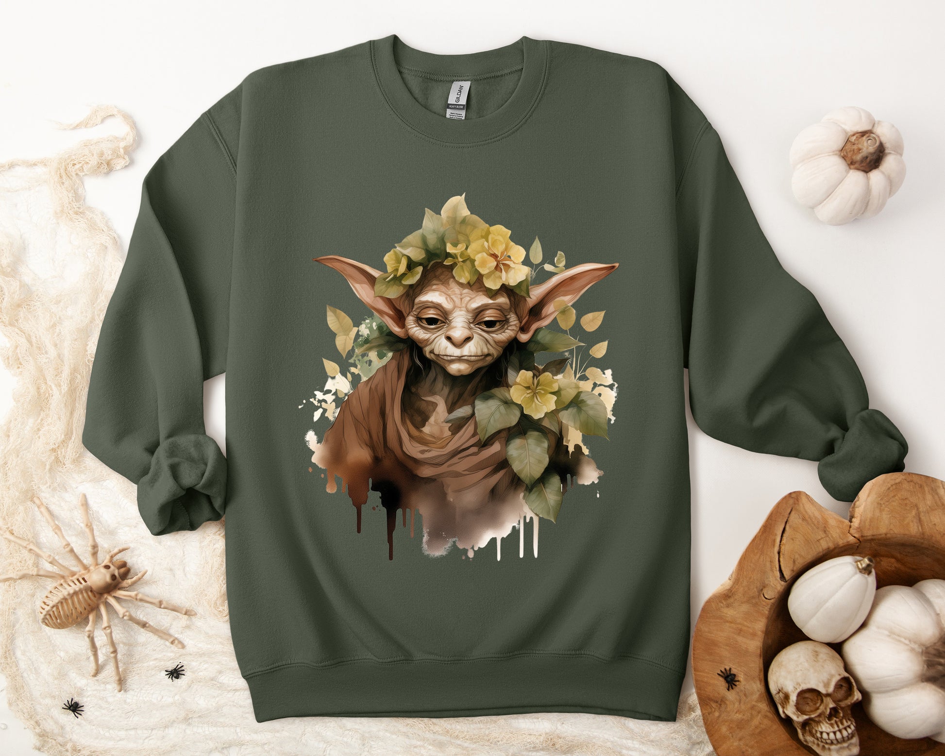 Mystical Goblin Boho Halloween Sweatshirt with a hand-drawn goblin illustration and boho-inspired design elements. Perfect for Halloween celebrations. Gildan 18000 sweatshirt in Military Green. ReadyShirtAim.com