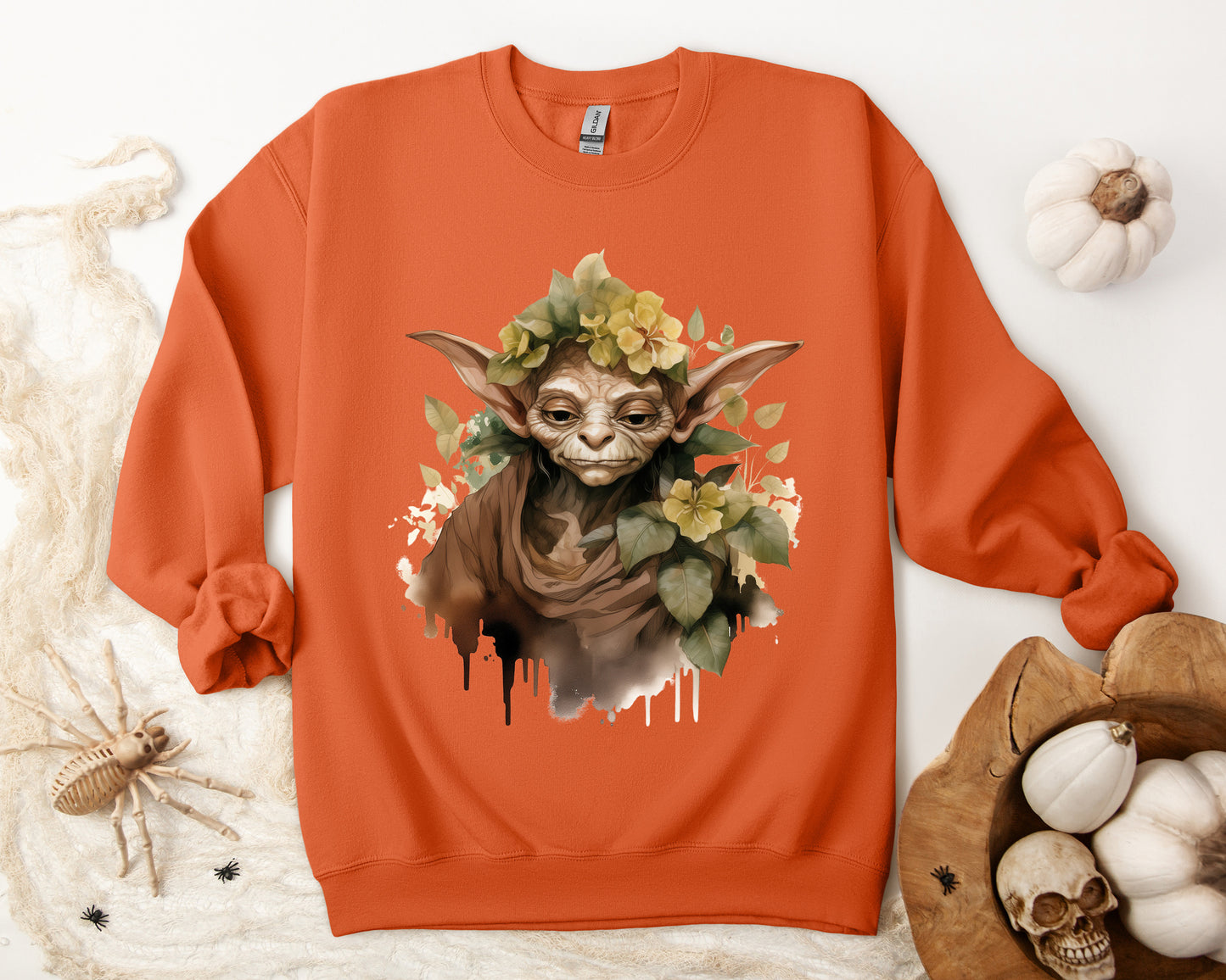 Mystical Goblin Boho Halloween Sweatshirt with a hand-drawn goblin illustration and boho-inspired design elements. Perfect for Halloween celebrations. Available in multiple dark and light colors and sizes. Gildan 18000 sweatshirt in Orange. ReadyShirtAim.com