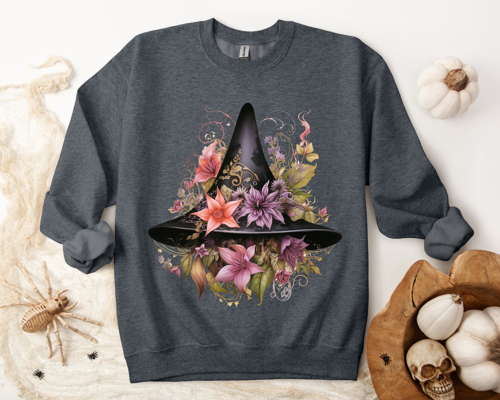 Whimsical Witch Hat Sweatshirt with a watercolor illustration of a black witch hat surrounded by flowers in purple, pink, and green. Available in multiple dark and light colors and sizes. Gildan 18000 sweatshirt in Dark Grey Heather. ReadyShirtAim.com