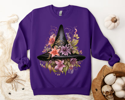 Whimsical Witch Hat Sweatshirt with a watercolor illustration of a black witch hat surrounded by flowers in purple, pink, and green. Available in multiple dark and light colors and sizes. Gildan 18000 sweatshirt in Purple. ReadyShirtAim.com