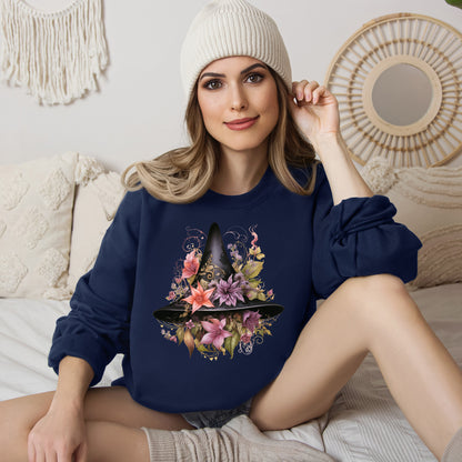 Whimsical Witch Hat Sweatshirt with a watercolor illustration of a black witch hat surrounded by flowers in purple, pink, and green. Available in multiple dark and light colors and sizes. Gildan 18000 sweatshirt in Navy. ReadyShirtAim.com