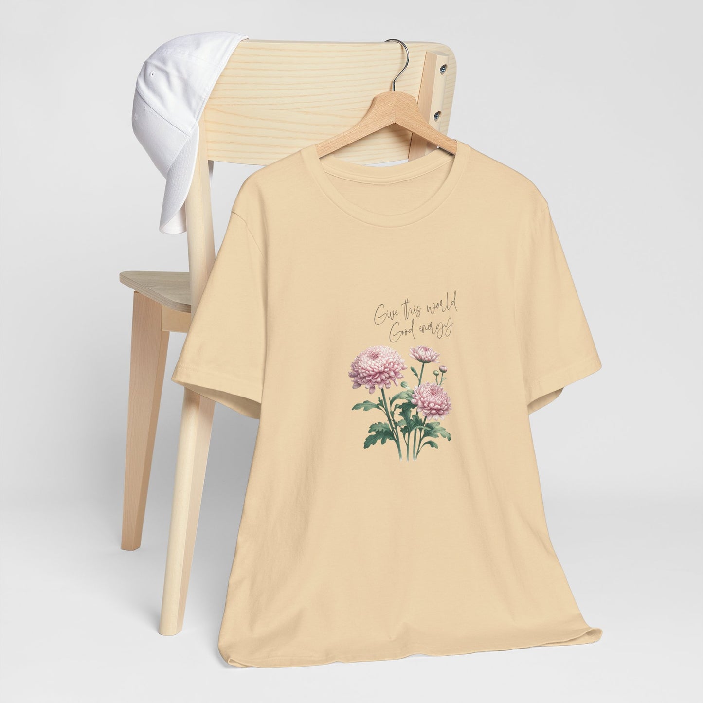 A t-shirt featuring a beautiful chrysanthemum for November with the quote “Give this world good energy.” Perfect for November birthdays and floral art lovers. Comfortable and stylish for casual outings or celebrations. Bella+Canvas 3001 t-shirt in soft cream. ReadyShirtAim.com