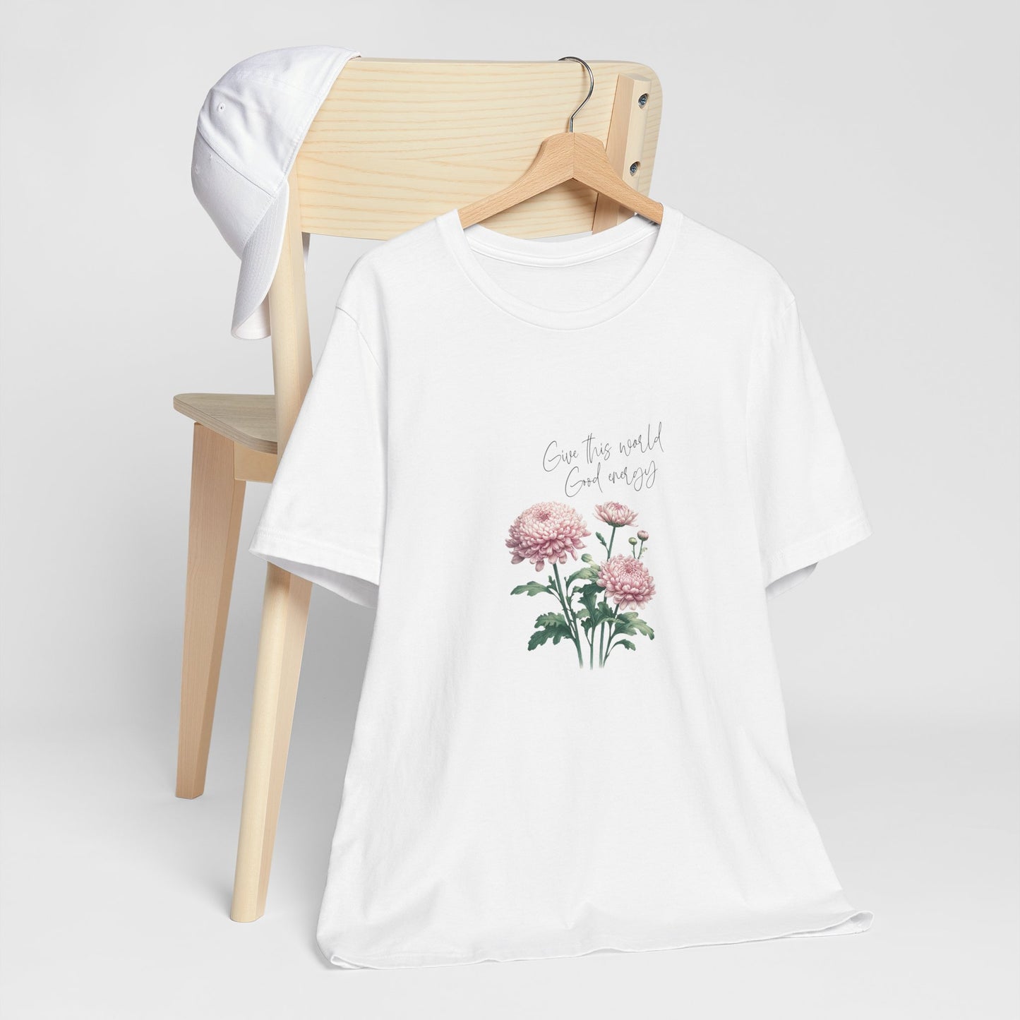 A t-shirt featuring a beautiful chrysanthemum for November with the quote “Give this world good energy.” Perfect for November birthdays and floral art lovers. Comfortable and stylish for casual outings or celebrations. Bella+Canvas 3001 t-shirt in white. ReadyShirtAim.com