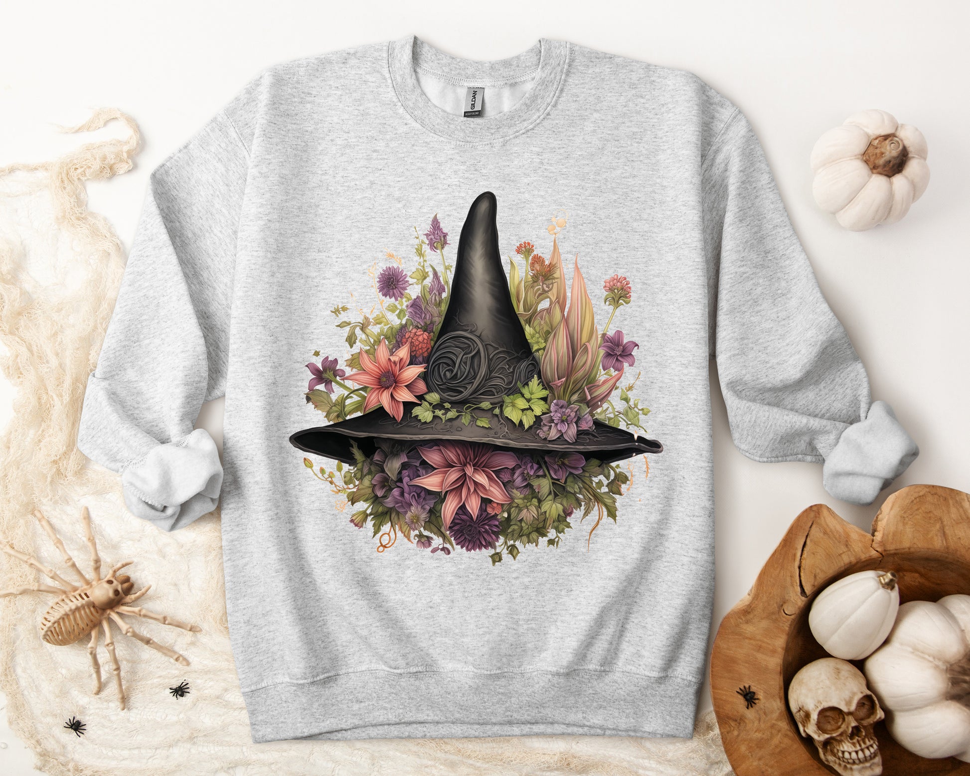 Gothic Boho Witch Hat & Flowers Halloween Sweatshirt for Women with a detailed witch hat and floral illustration. Perfect for Halloween celebrations. Available in multiple dark and light colors and sizes. Gildan 18000 sweatshirt in ash. ReadyShirtAim.com