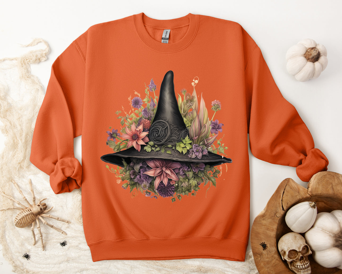 Gothic Boho Witch Hat & Flowers Halloween Sweatshirt for Women with a detailed witch hat and floral illustration. Perfect for Halloween celebrations. Available in multiple dark and light colors and sizes. Gildan 18000 sweatshirt in Orange. ReadyShirtAim.com