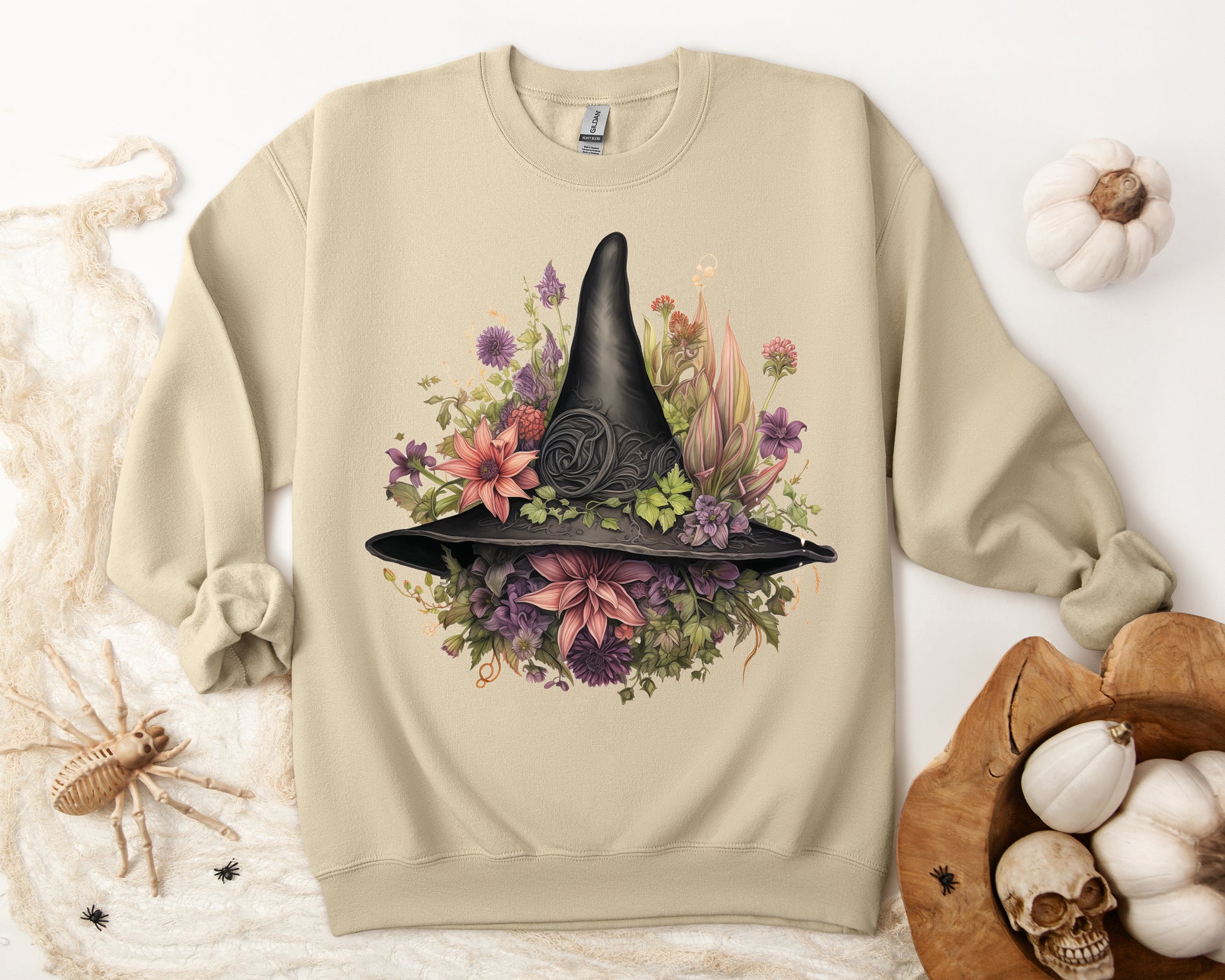 Gothic Boho Witch Hat & Flowers Halloween Sweatshirt for Women with a detailed witch hat and floral illustration. Perfect for Halloween celebrations. Available in multiple dark and light colors and sizes. Gildan 18000 sweatshirt in Sand. ReadyShirtAim.com