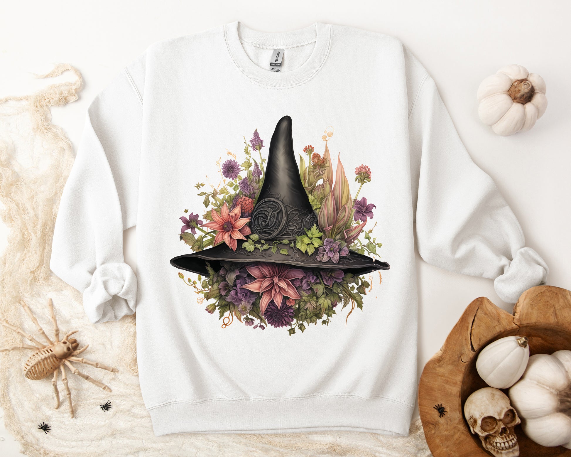 Gothic Boho Witch Hat & Flowers Halloween Sweatshirt for Women with a detailed witch hat and floral illustration. Perfect for Halloween celebrations. Available in multiple dark and light colors and sizes. Gildan 18000 sweatshirt in white. ReadyShirtAim.com