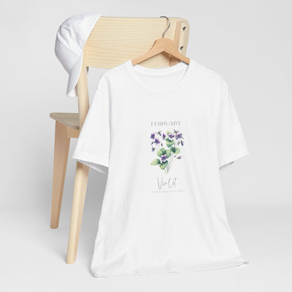 A t-shirt featuring a beautiful violet for February with traits Virtue, Modesty, Humility. Perfect for February birthdays and floral art lovers. Comfortable and stylish for casual outings or celebrations. Bella+Canvas 3001 t-shirt in white. ReadyShirtAim.com