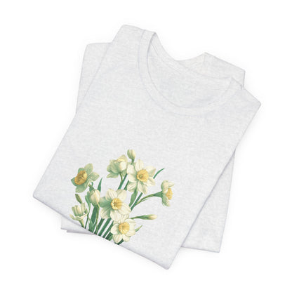 A t-shirt featuring a beautiful narcissus for December. Perfect for December birthdays and floral art lovers. Comfortable and stylish for casual outings or celebrations. Bella+Canvas 3001 t-shirt in white. ReadyShirtAim.com