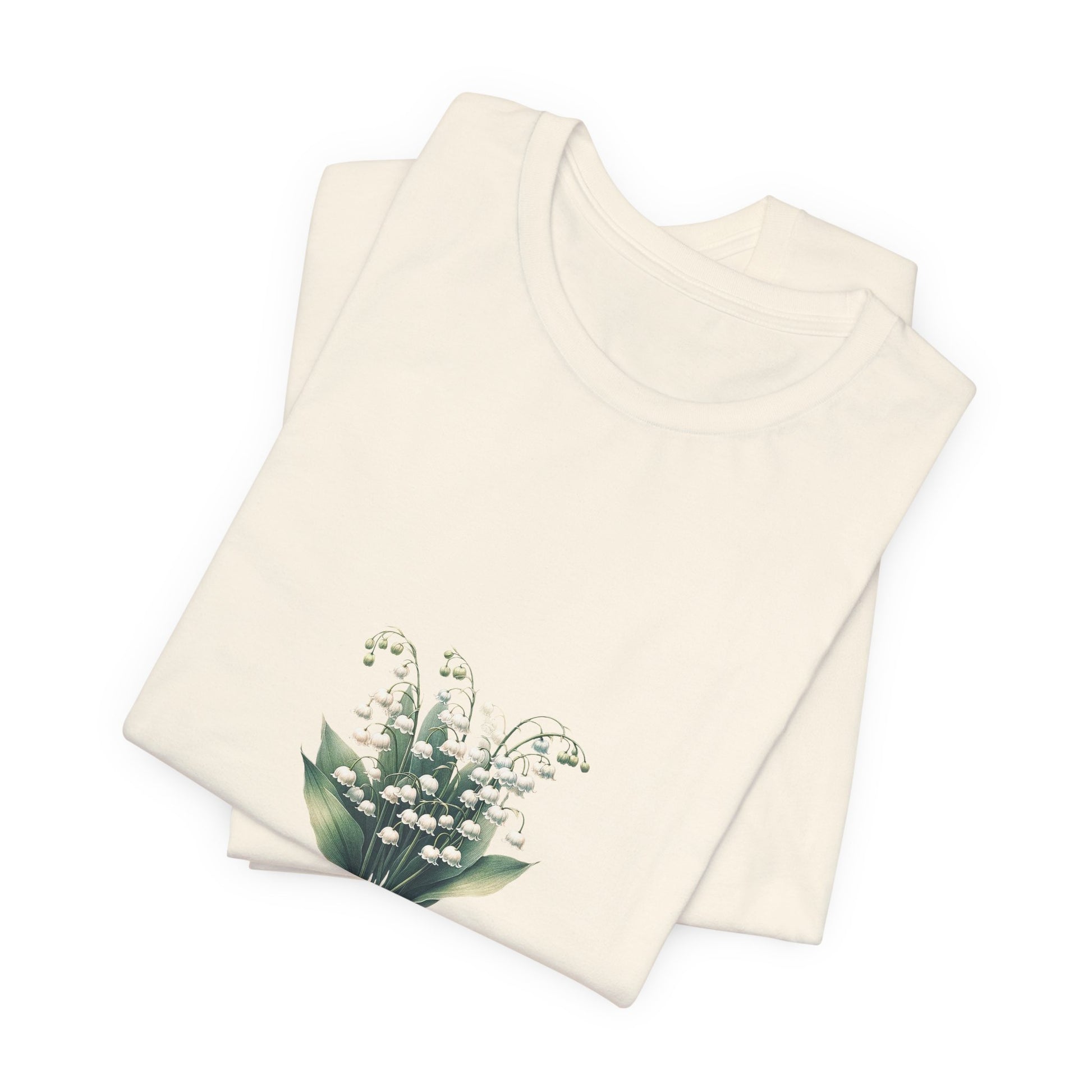 A t-shirt featuring a beautiful Lily of the Valley for May with the quote “Be your own reason to smile.” Perfect for May birthdays and floral art lovers. Comfortable and stylish for casual outings or celebrations. Bella+Canvas 3001 t-shirt in natural. ReadyShirtAim.com