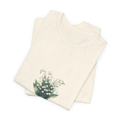 A t-shirt featuring a beautiful Lily of the Valley for May with the quote “Be your own reason to smile.” Perfect for May birthdays and floral art lovers. Comfortable and stylish for casual outings or celebrations. Bella+Canvas 3001 t-shirt in natural. ReadyShirtAim.com