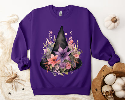 Feminine Witchy Vibes Boho Halloween Sweatshirt for her, featuring a watercolor illustration of a black witch hat and flowers in purple, pink, and green. Available in multiple dark and light colors and sizes. Gildan 18000 sweatshirt in Purple. ReadyShirtAim.com