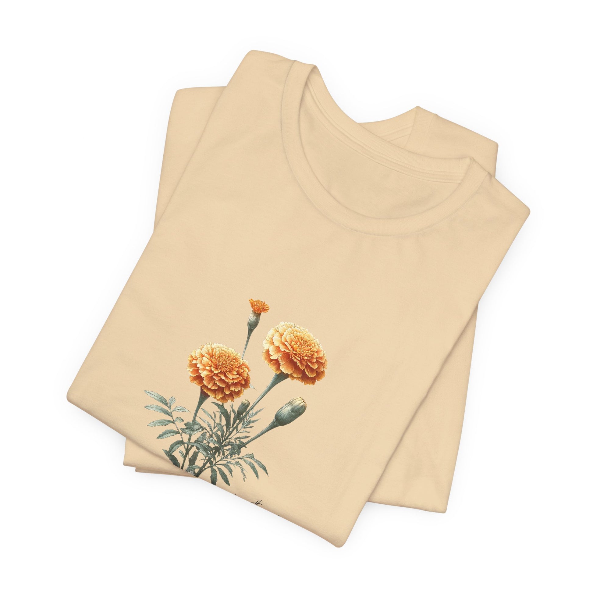 A t-shirt featuring a beautiful marigold for October with the quote “Expect nothing, appreciate everything.” Perfect for October birthdays and floral art lovers. Comfortable and stylish for casual outings or celebrations. Bella+Canvas 3001 t-shirt in soft cream. ReadyShirtAim.com