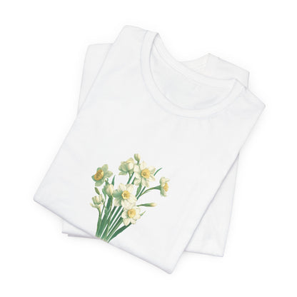 A t-shirt featuring a beautiful narcissus for December with the quote “Peaceful mind, grateful heart.” Perfect for December birthdays and floral art lovers. Comfortable and stylish for casual outings or celebrations. Bella+Canvas 3001 t-shirt in white. ReadyShirtAim.com