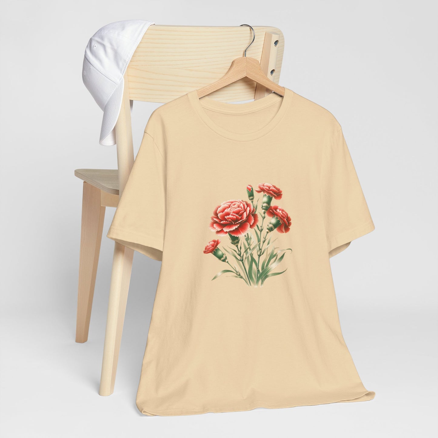 A t-shirt featuring a beautiful carnation for January. Perfect for January birthdays and floral art lovers. Comfortable and stylish for casual outings or celebrations. Bella+Canvas 3001 t-shirt in soft cream. ReadyShirtAim.com