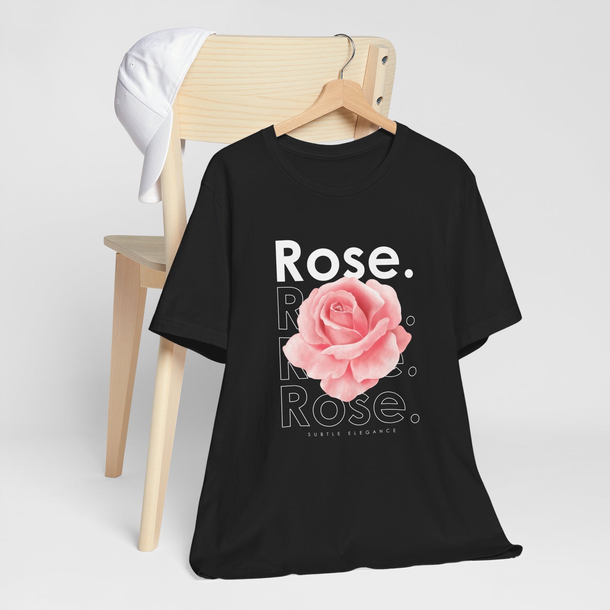 A t-shirt featuring a beautiful pale pink watercolor rose with the theme 'Subtle Elegance.' Perfect for those who adore floral art and nature. Comfortable and stylish for casual outings or celebrations. Bella+Canvas 3001 t-shirt in black. ReadyShirtAim.com