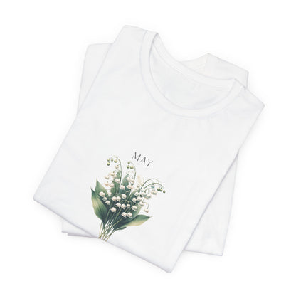 A t-shirt featuring a beautiful Lily of the Valley for May with traits Motherhood, Sweetness, Purity. Perfect for May birthdays and floral art lovers. Comfortable and stylish for casual outings or celebrations. Bella+Canvas 3001 t-shirt in white. ReadyShirtAim.com