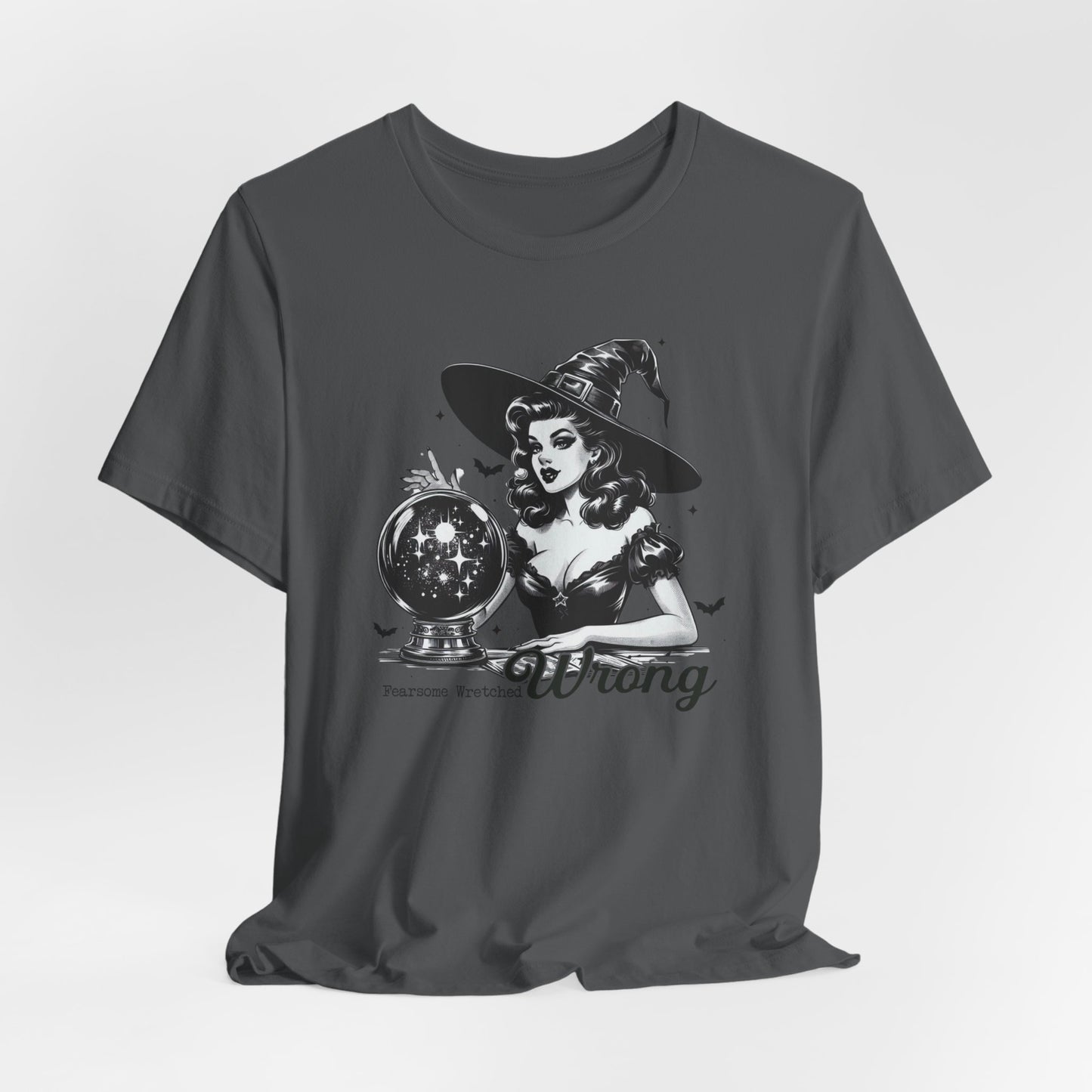 "Fearsome, Wretched, Wrong" Vintage 1950's Witch Halloween Women's T-Shirt featuring bold black text and a classic black-and-white image of a pin-up girl in a sexy witch costume, gazing into a large crystal ball full of stars and sparkles, with bats and stars in the background, perfect for adding a retro touch with mystical charm to your Halloween festivities. Available in multiple colors and sizes.  Bella+Canvas 3001 t-shirt in asphalt. ReadyShirtAim.com