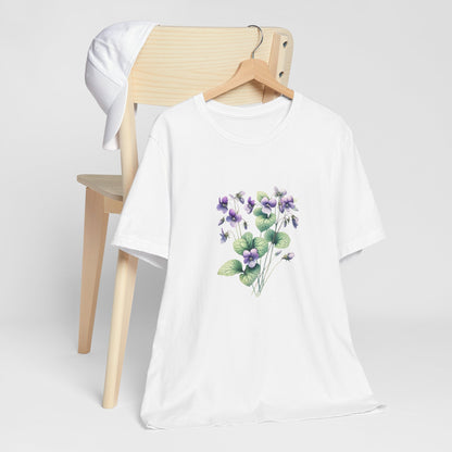 A t-shirt featuring a beautiful violet for February. Perfect for February birthdays and floral art lovers. Comfortable and stylish for casual outings or celebrations. Bella+Canvas 3001 t-shirt in white. ReadyShirtAim.com