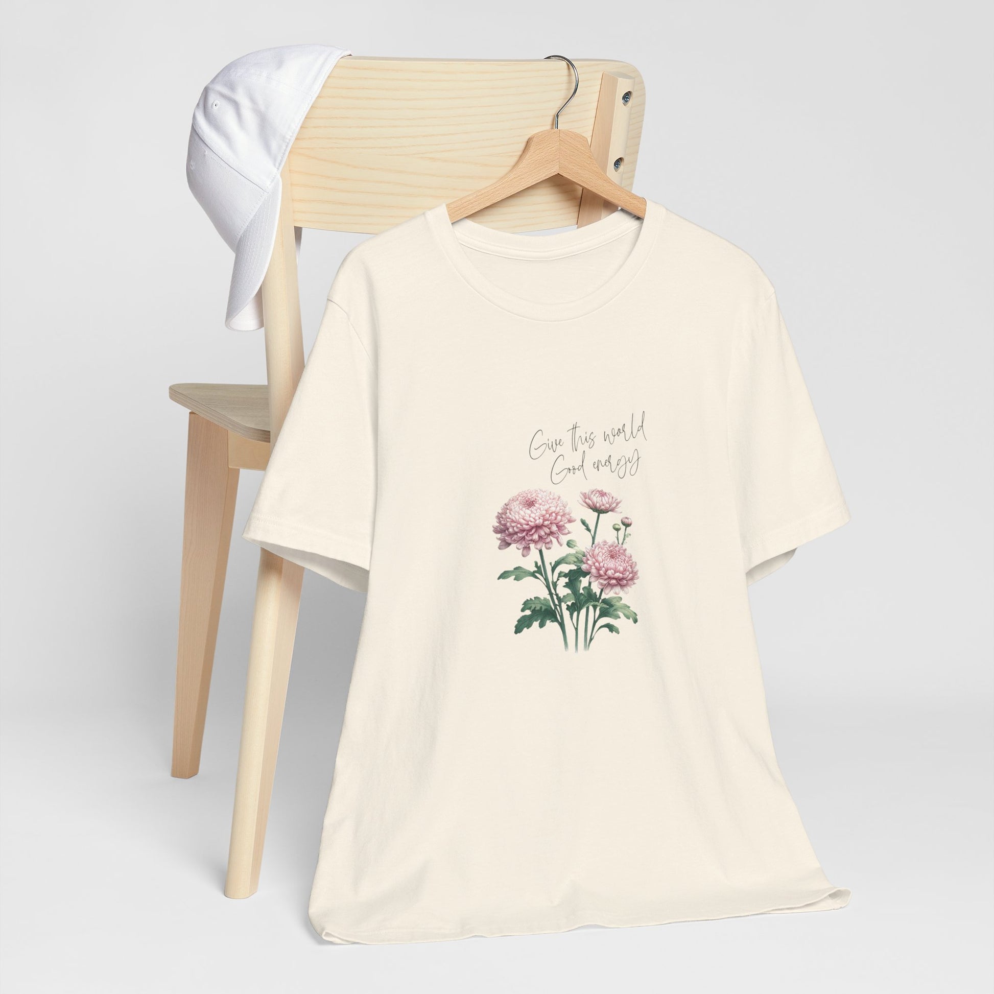 A t-shirt featuring a beautiful chrysanthemum for November with the quote “Give this world good energy.” Perfect for November birthdays and floral art lovers. Comfortable and stylish for casual outings or celebrations. Bella+Canvas 3001 t-shirt in natural. ReadyShirtAim.com