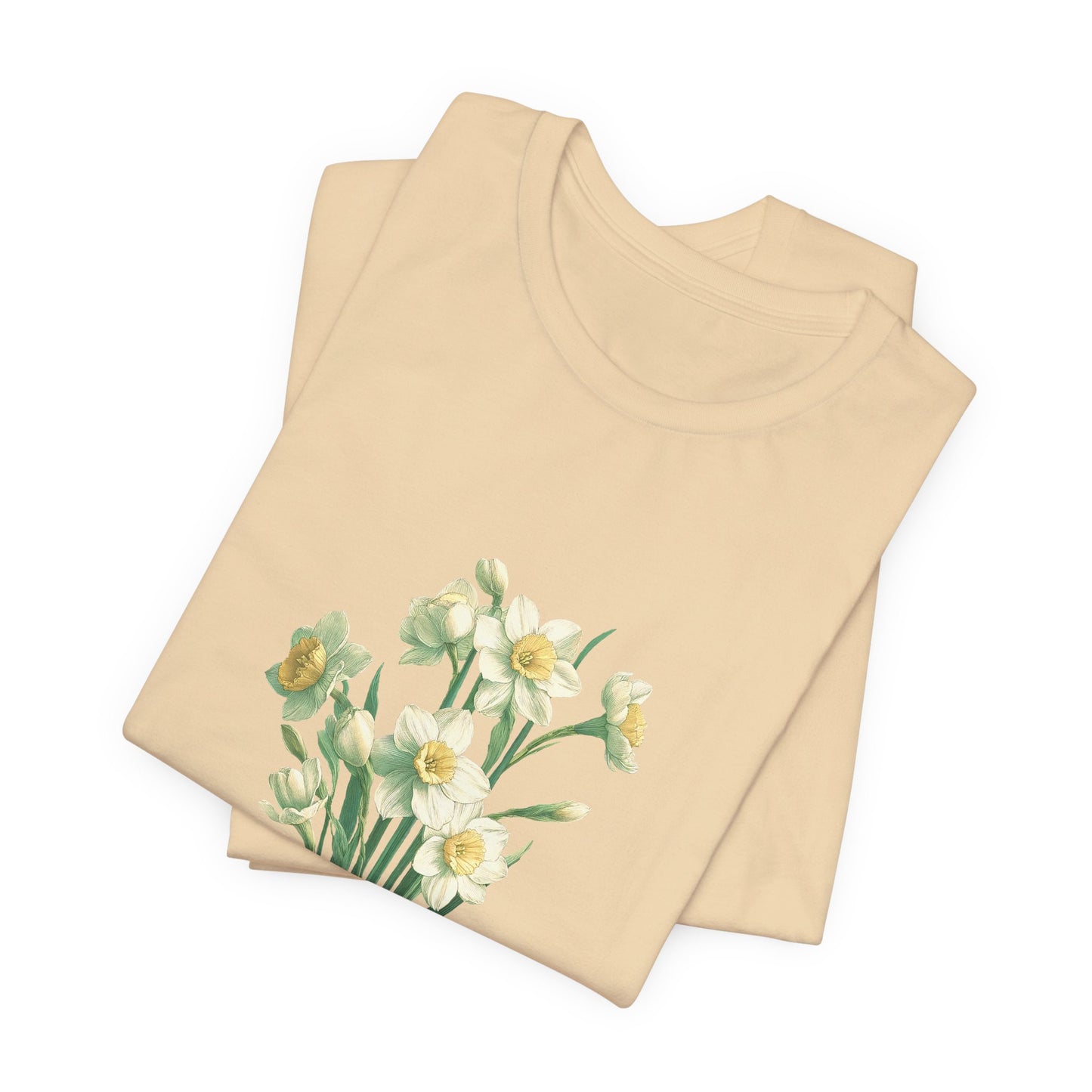 A t-shirt featuring a beautiful narcissus for December. Perfect for December birthdays and floral art lovers. Comfortable and stylish for casual outings or celebrations. Bella+Canvas 3001 t-shirt in soft cream. ReadyShirtAim.com