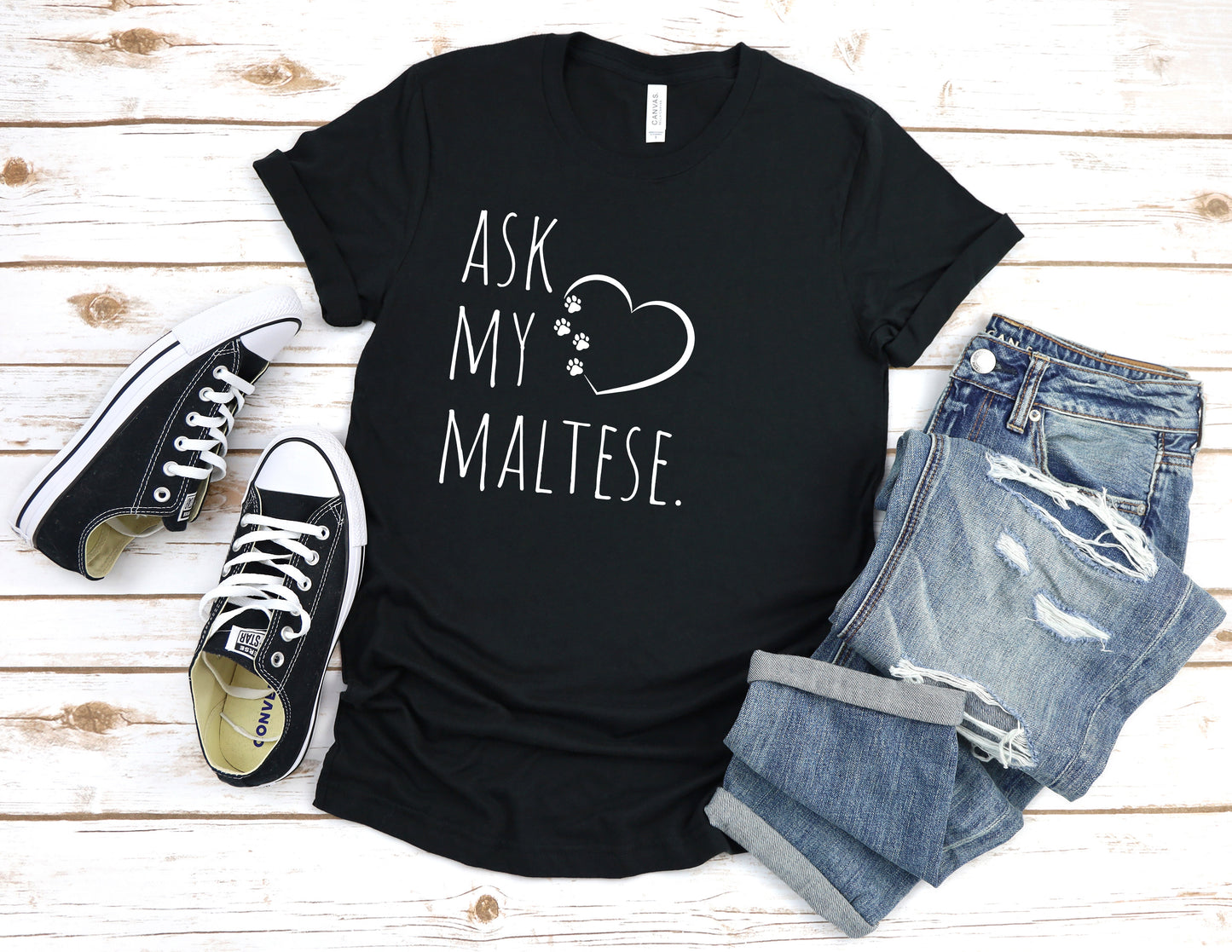 "Ask My Maltese" T-Shirt featuring a heart with two paw prints, perfect for dog lovers and Maltese owners. Unisex design for men and women. Available in multiple colors and sizes. Bella+Canvas 3001 t-shirt in black. ReadyShirtAim.com