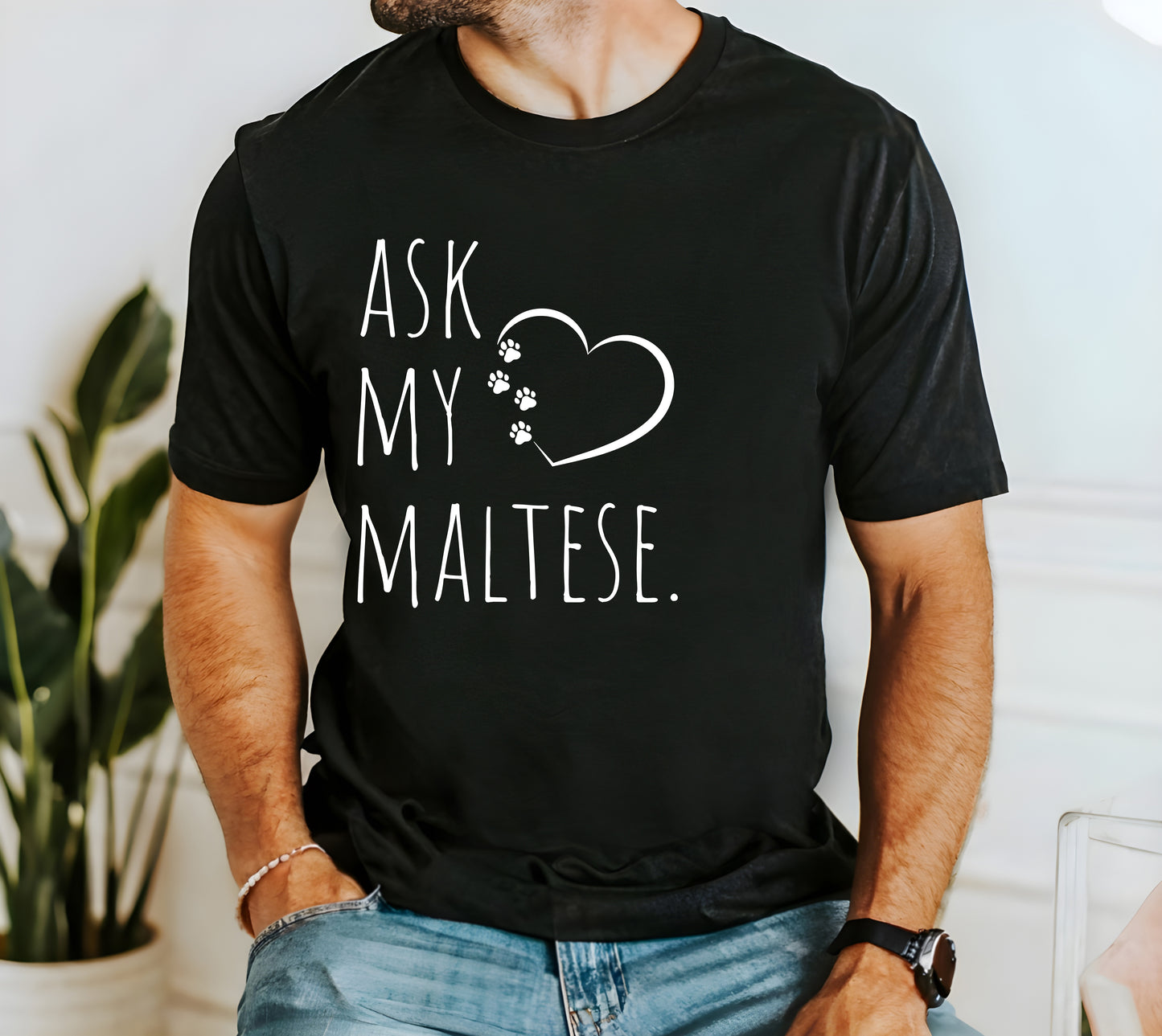 "Ask My Maltese" T-Shirt featuring a heart with two paw prints, perfect for dog lovers and Maltese owners. Unisex design for men and women. Available in multiple colors and sizes. Bella+Canvas 3001 t-shirt in black. ReadyShirtAim.com