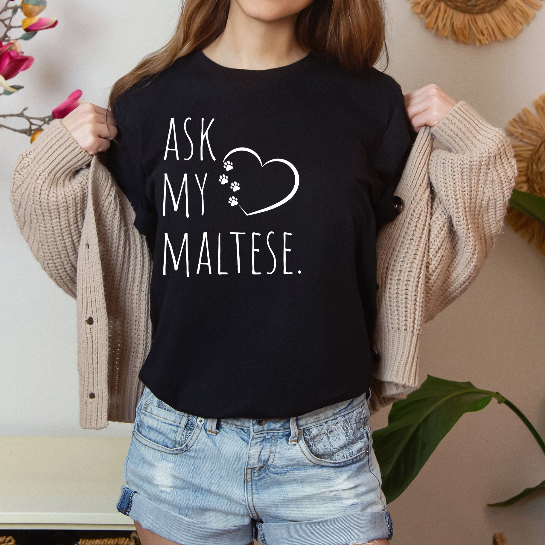 "Ask My Maltese" T-Shirt featuring a heart with two paw prints, perfect for dog lovers and Maltese owners. Unisex design for men and women. Available in multiple colors and sizes. Bella+Canvas 3001 t-shirt in black. ReadyShirtAim.com