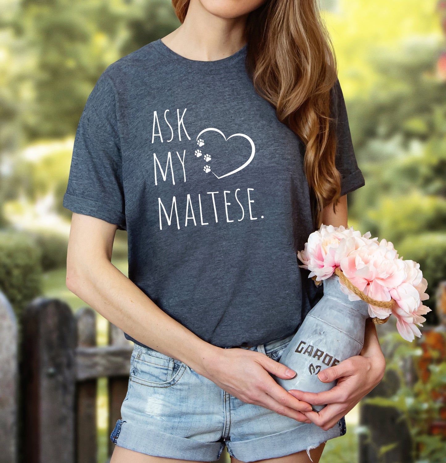 "Ask My Maltese" T-Shirt featuring a heart with two paw prints, perfect for dog lovers and Maltese owners. Unisex design for men and women. Available in multiple colors and sizes. Bella+Canvas 3001 t-shirt in dark grey heather. ReadyShirtAim.com