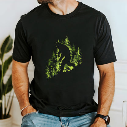 A t-shirt featuring an artistic depiction of a Bigfoot encounter, perfect for cryptid enthusiasts, outdoor adventurers, and mystery lovers. Comfortable and stylish for casual outings or cryptid conventions. Bella+Canvas 3001 t-shirt in black. ReadyShirtAim.com