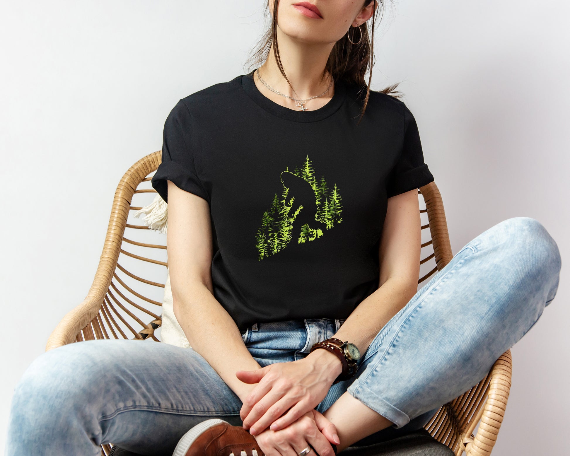 A t-shirt featuring an artistic depiction of a Bigfoot encounter, perfect for cryptid enthusiasts, outdoor adventurers, and mystery lovers. Comfortable and stylish for casual outings or cryptid conventions. Bella+Canvas 3001 t-shirt in black. ReadyShirtAim.com