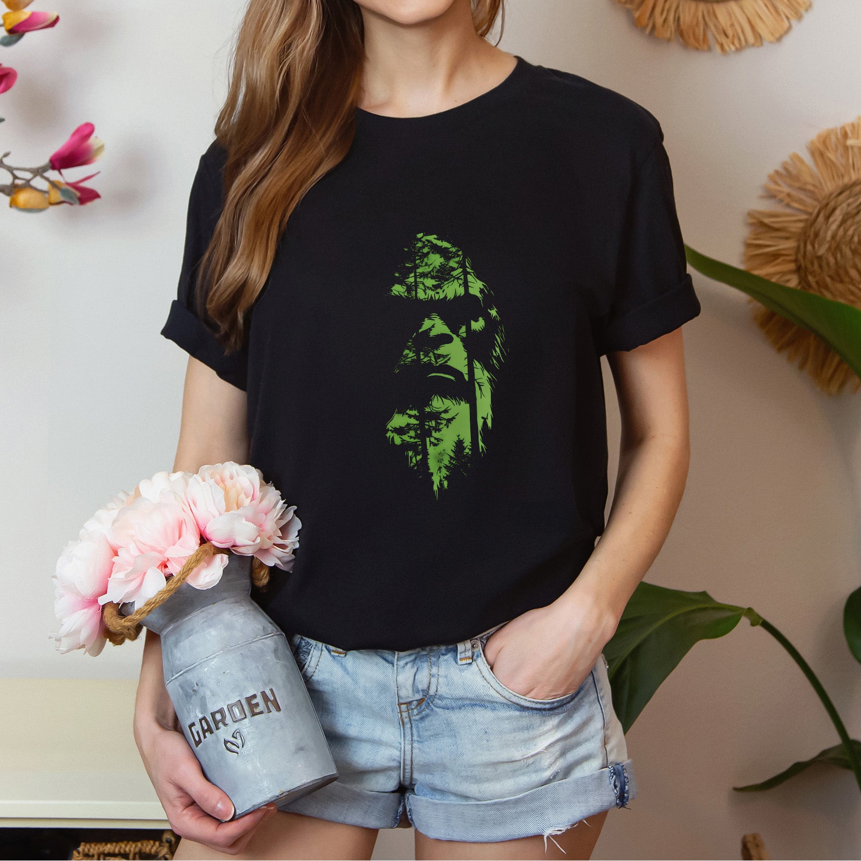 A t-shirt featuring an enigmatic cryptid design of Bigfoot's face, perfect for Bigfoot enthusiasts, cryptid fans, and adventure seekers. Comfortable and stylish for casual outings or cryptid conventions. Bella+Canvas 3001 t-shirt in black. ReadyShirtAim.com