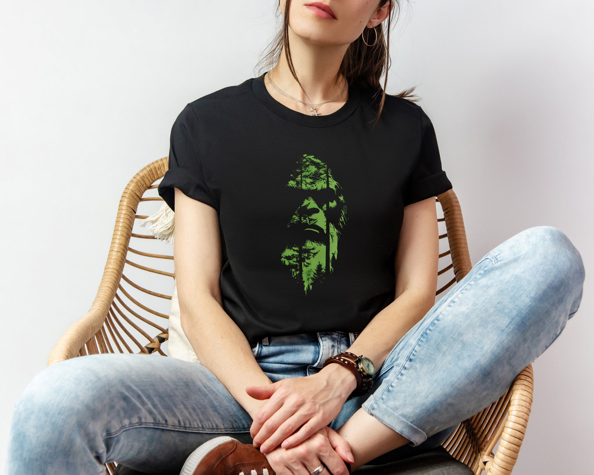 A t-shirt featuring an enigmatic cryptid design of Bigfoot's face, perfect for Bigfoot enthusiasts, cryptid fans, and adventure seekers. Comfortable and stylish for casual outings or cryptid conventions. Bella+Canvas 3001 t-shirt in black. ReadyShirtAim.com