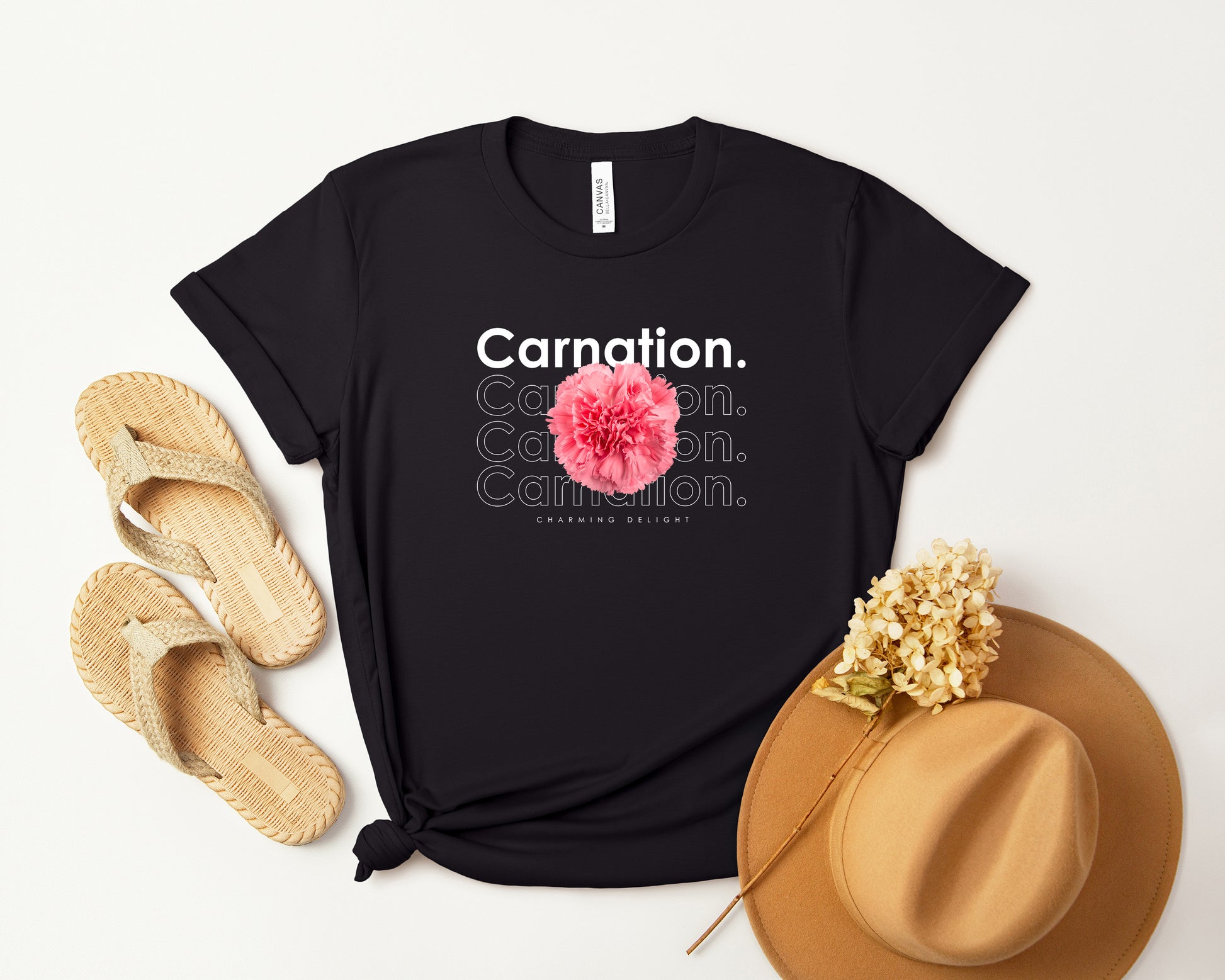 A photo-realistic pink carnation t-shirt with a bold contemporary floral design and the caption "Charming Delight." Perfect for carnation lovers, botanical enthusiasts, and nature lovers. Bella+Canvas 3001 t-shirt in black. ReadyShirtAim.com