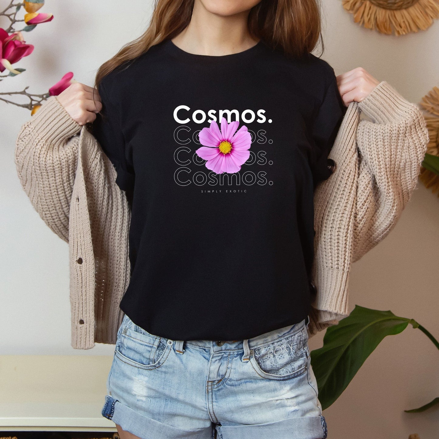 A photo-realistic mauve on fuchsia and yellow cosmos t-shirt with a bold contemporary floral design and the caption "Simply Exotic." Perfect for cosmos lovers, botanical enthusiasts, and nature lovers. Bella+Canvas 3001 t-shirt in black. ReadyShirtAim.com