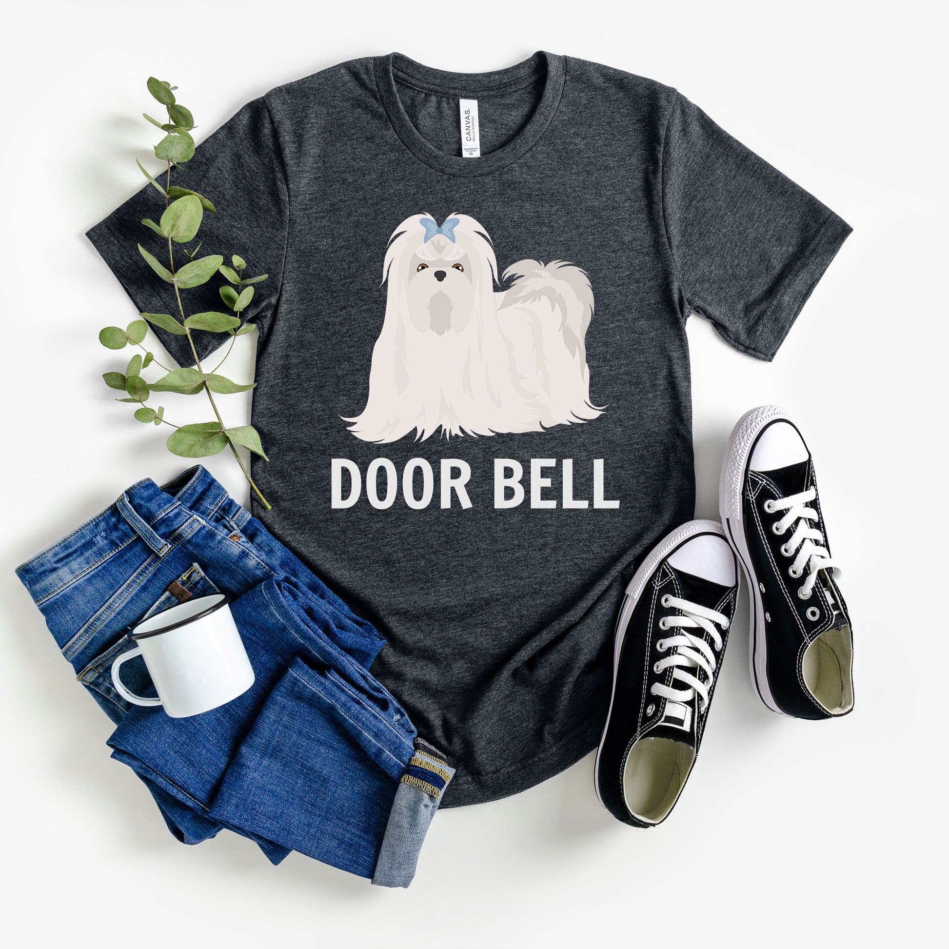 "Door Bell" Maltese Dog T-Shirt for Unisex with a beige silhouette of a Maltese dog and playful "Door Bell" text underneath. Ideal for dog lovers with a sense of humor. Available in multiple colors and sizes. Bella+Canvas 3001 t-shirt in dark grey heather. ReadyShirtAim.com