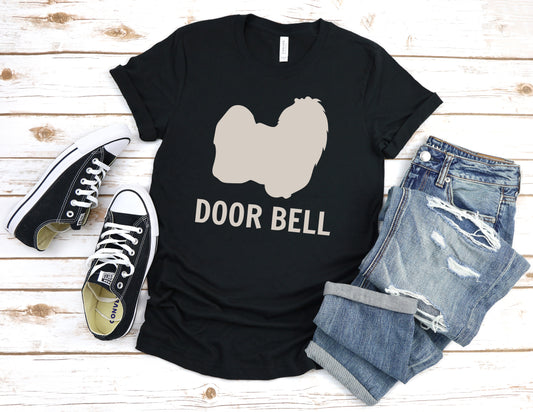 "Door Bell" Maltese Dog T-Shirt for Unisex with a beige silhouette of a Maltese dog and playful "Door Bell" text underneath. Ideal for dog lovers with a sense of humor. Available in multiple colors and sizes. Bella+Canvas 3001 t-shirt in black. ReadyShirtAim.com