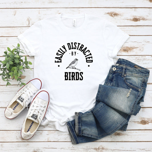 A vintage typeface t-shirt with a hand-drawn sketch of an amphibian and the caption "Easily Distracted by Amphibians." Perfect for amphibian lovers, herpetologists, and nature enthusiasts. Bella+Canvas 3001 t-shirt in white. ReadyShirtAim.com