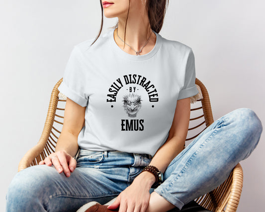 A vintage typeface t-shirt with a hand-drawn sketch of an emu and the caption "Easily Distracted by Emus." Perfect for emu lovers, bird watchers, and wildlife enthusiasts. Bella+Canvas 3001 t-shirt in silver. ReadyShirtAim.com