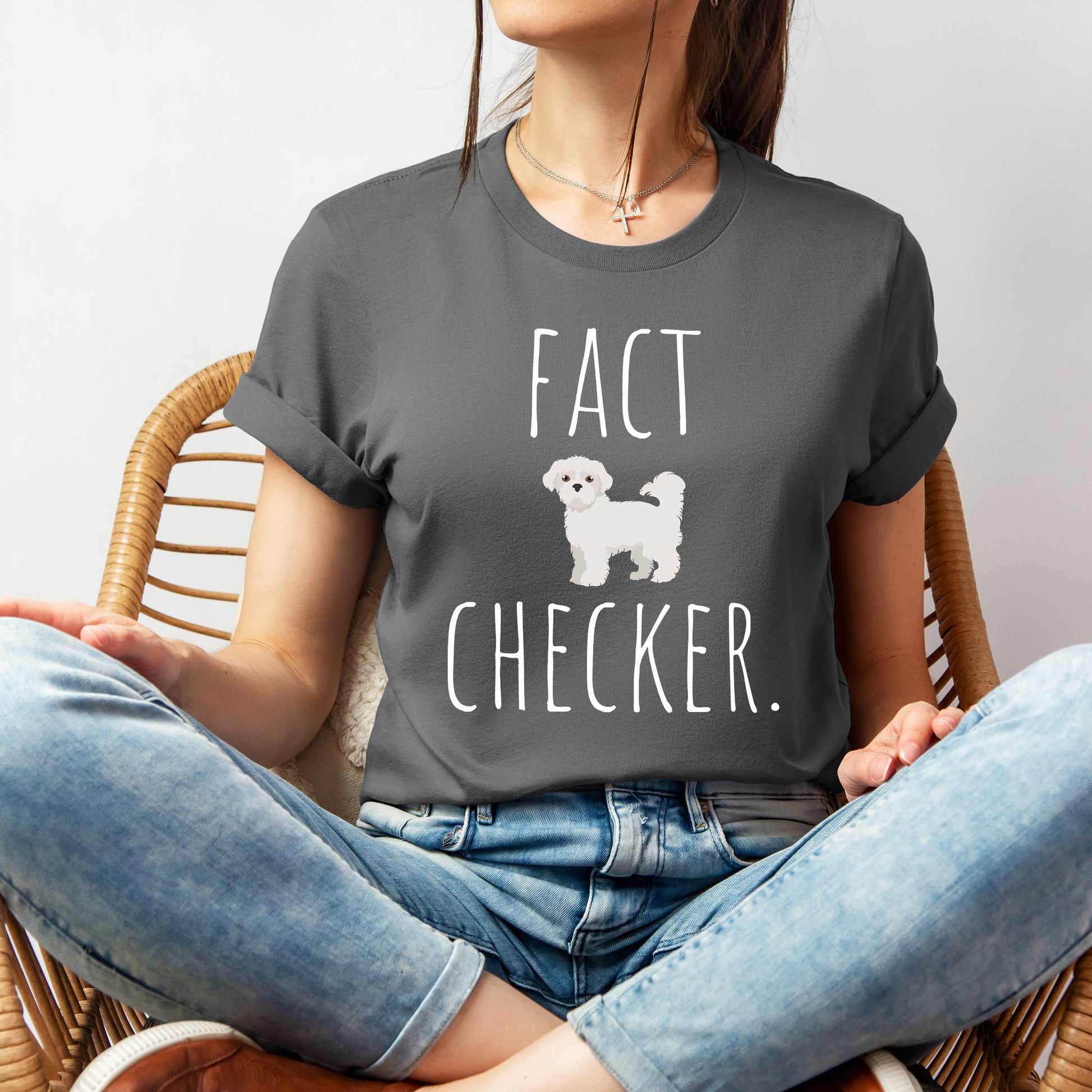 "Fact Checker" Maltese Dog T-Shirt for Unisex with a cute graphic of a Maltese dog and playful "Fact Checker" text underneath. Ideal for dog lovers. Ideal for dog lovers with a sense of humor. Available in multiple colors and sizes. Bella+Canvas 3001 t-shirt in asphalt. ReadyShirtAim.com