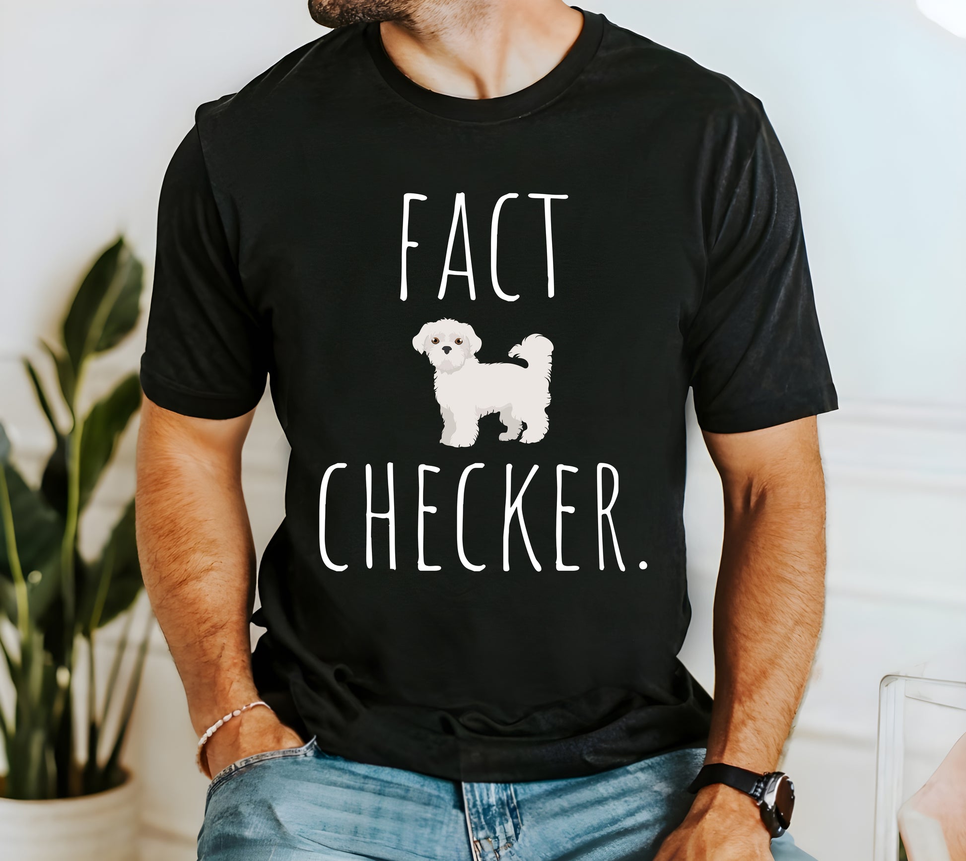 "Fact Checker" Maltese Dog T-Shirt for Unisex with a cute graphic of a Maltese dog and playful "Fact Checker" text underneath. Ideal for dog lovers. Ideal for dog lovers with a sense of humor. Available in multiple colors and sizes. Bella+Canvas 3001 t-shirt in black. ReadyShirtAim.com